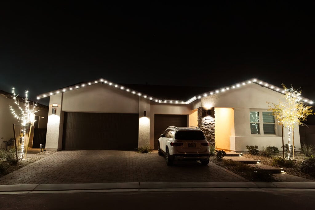 Pure white Christmas light installation on a Las Vegas home