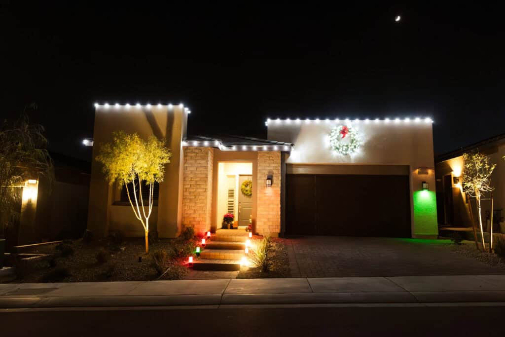 Pure white Christmas light installation on a Las Vegas home