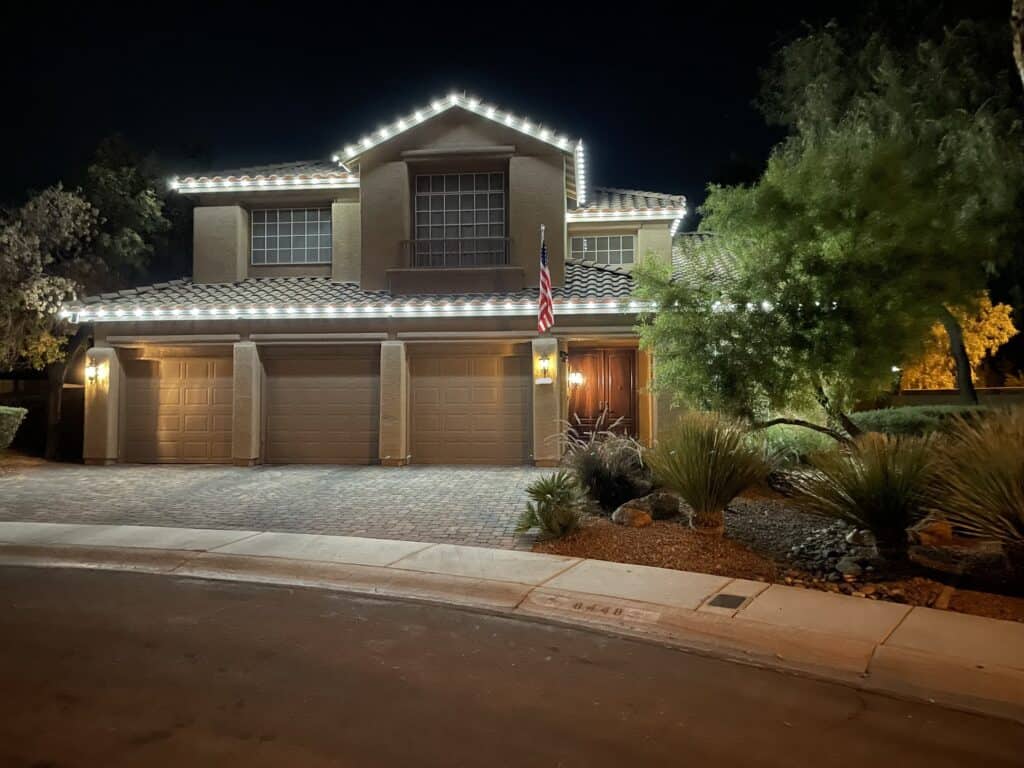 Pure white Christmas light installation on a Las Vegas home