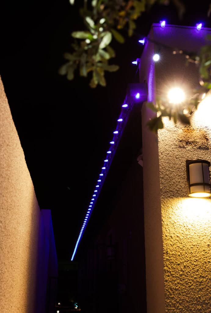 Purple Christmas Lights Installed on the tile roof of a stucco home in Las Vegas