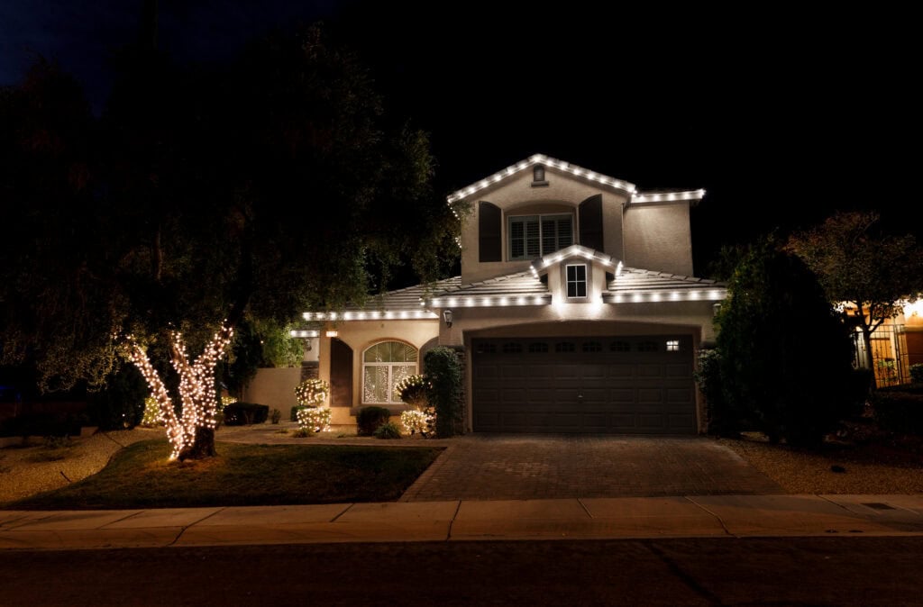 Pure white Christmas lights outlining a peaked roofline