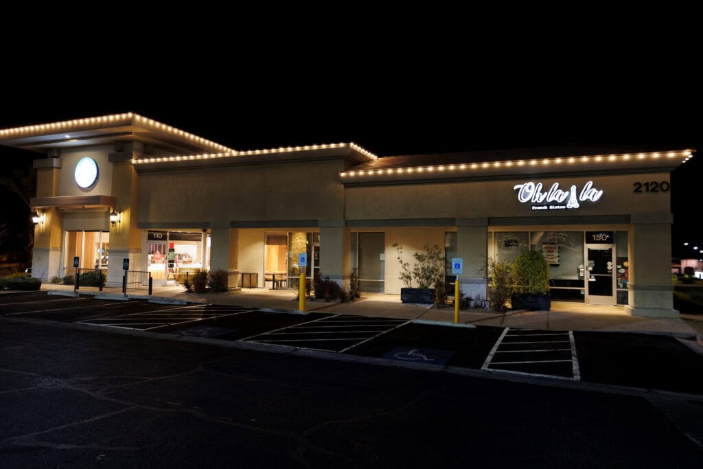 Christmas lights installed on businesses in strip mall to look festive and clean. Professional, top rated christmas light installation company in Austin, Texas is Light Up USA